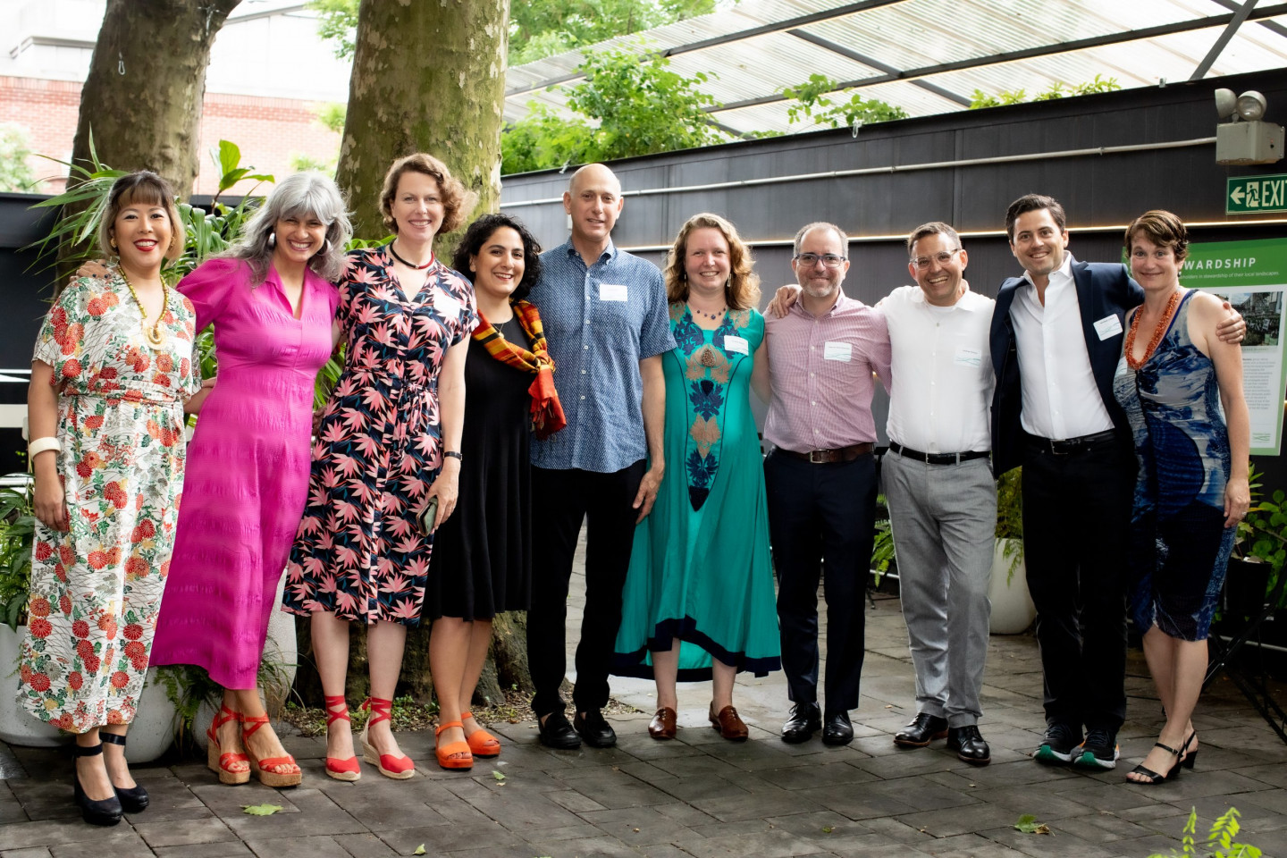 Nine Gowanus Canal Conservancy Board Members and Executive Director Andrea Parker smile at spring gala